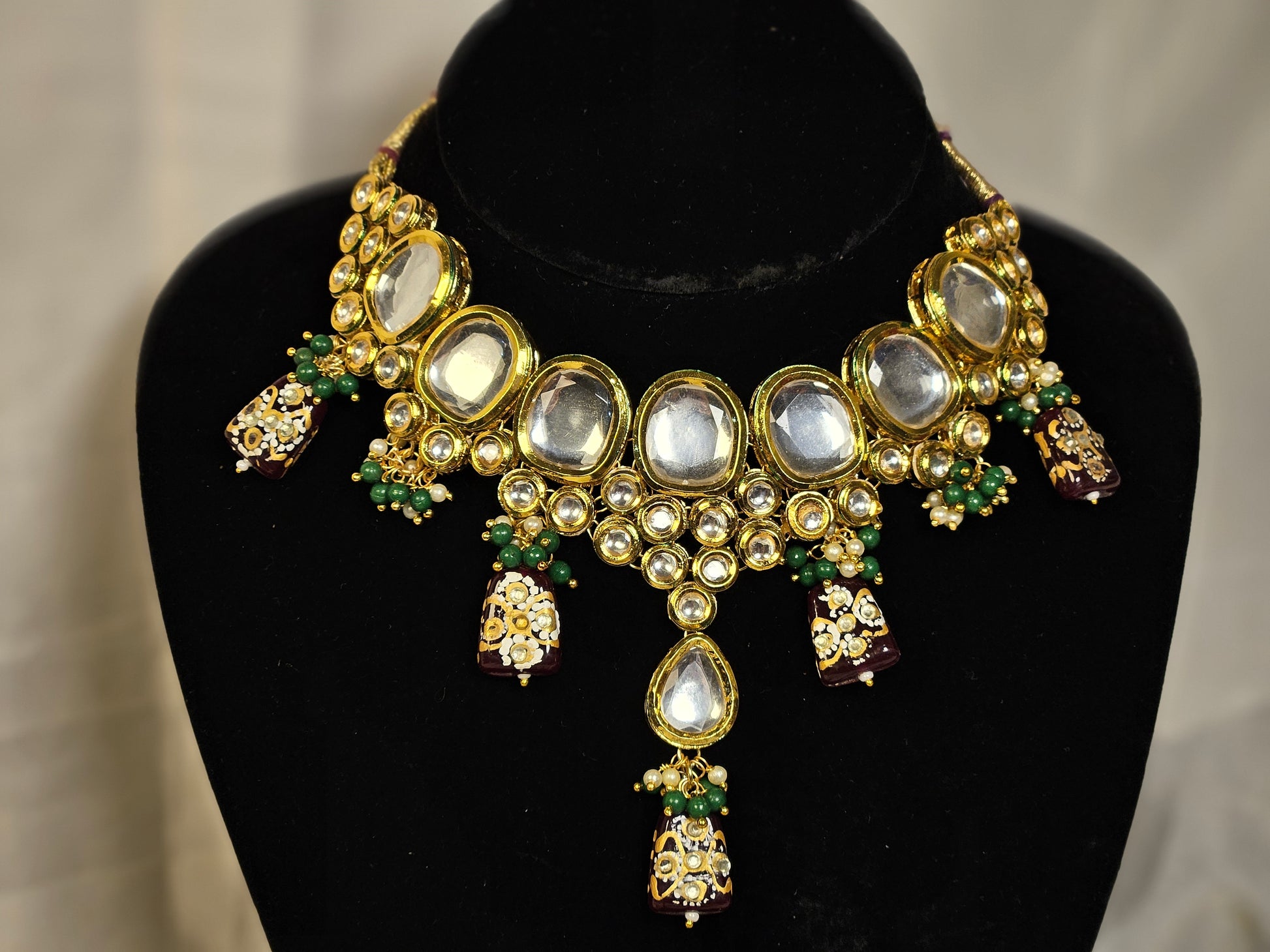 Intricate Indian jewelry necklace with gold accents, mirror stones, and colorful beads from Wincham Fashion House