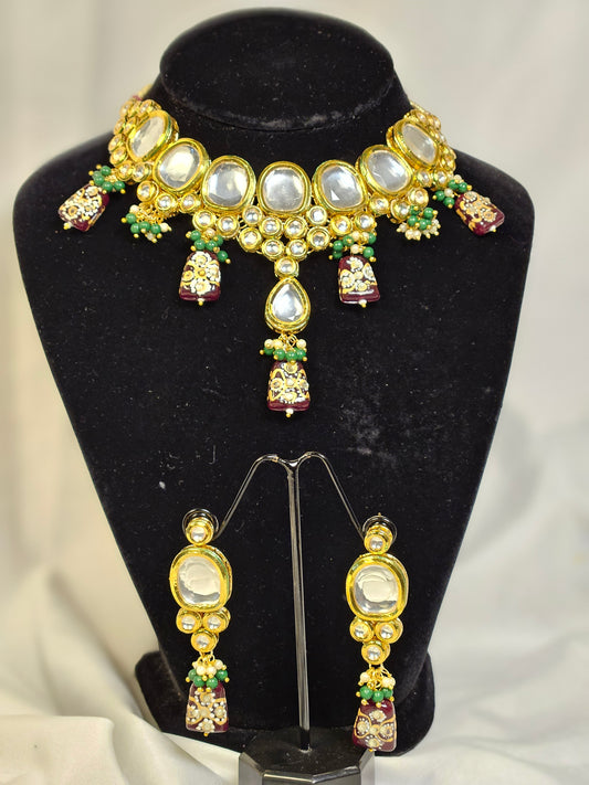 Elegant Indian jewelry set featuring intricate necklace and earrings with pearls and colorful stones