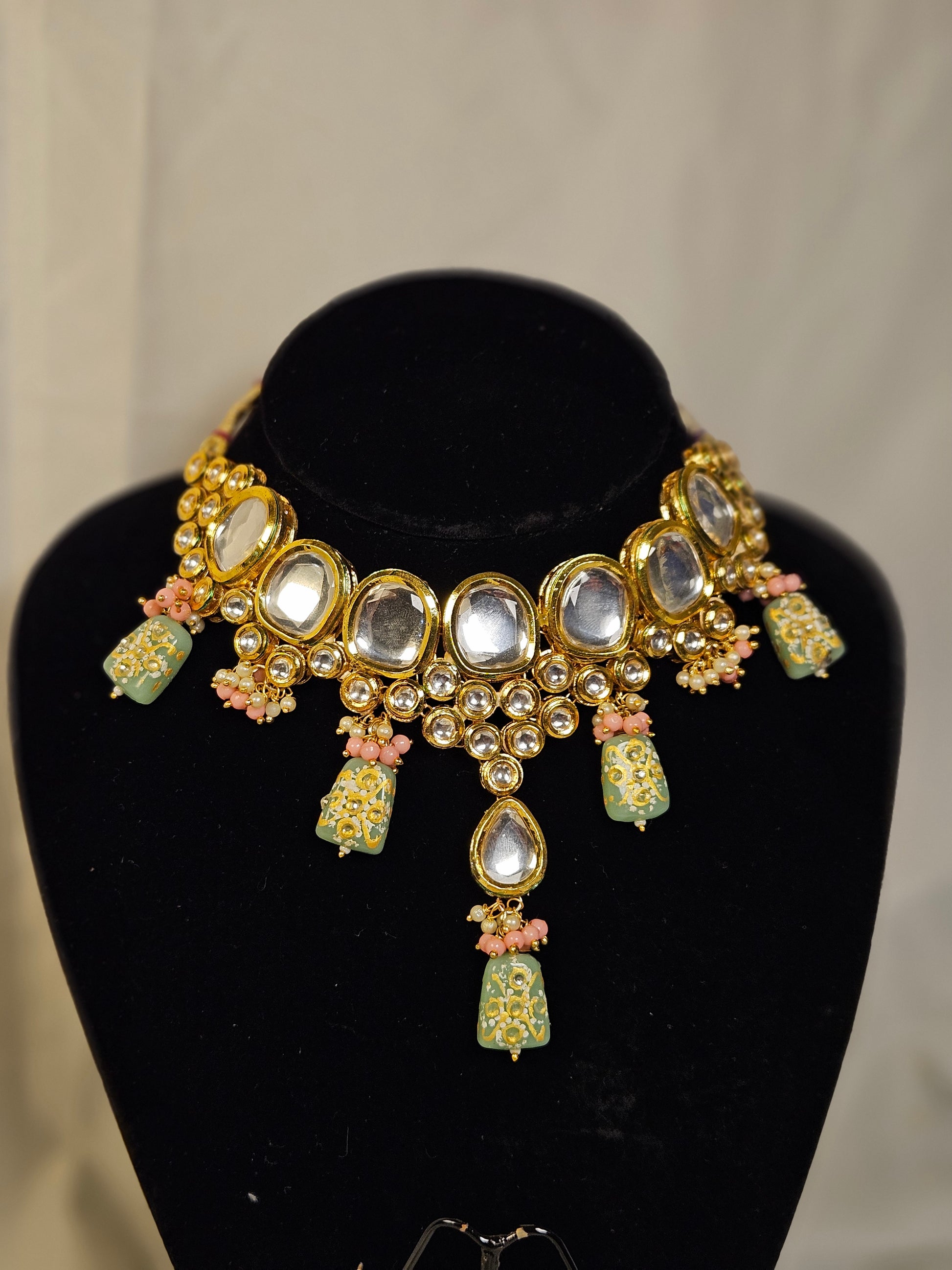 Traditional Indian jewelry necklace with intricate designs and colorful embellishments
