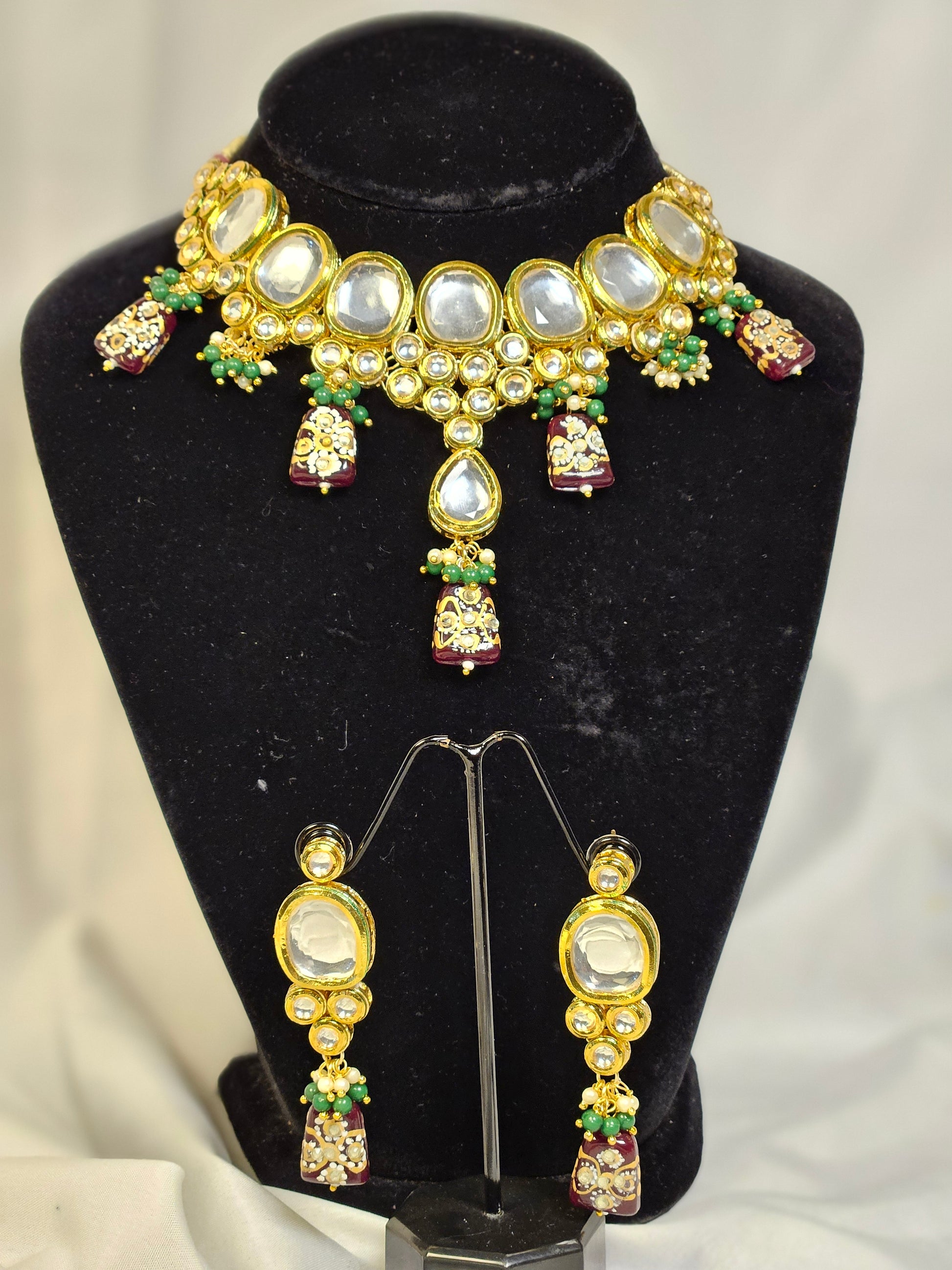 Wincham Fashion House Indian jewelry set featuring a statement necklace and matching earrings adorned with colorful gemstones