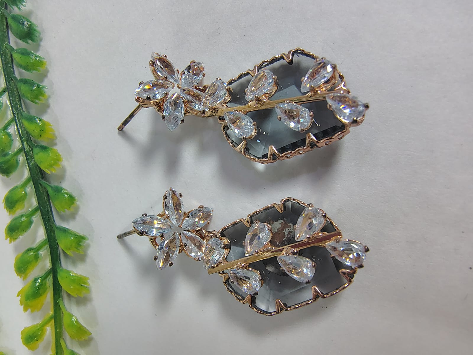 Elegant stud diamond earrings featuring floral design and sparkling stone accents