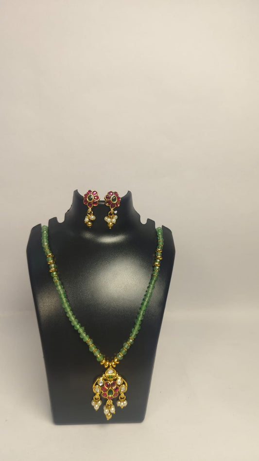 Elegant Wincham Fashion House jodhpuri necklace set with earrings featuring green beads and red accents