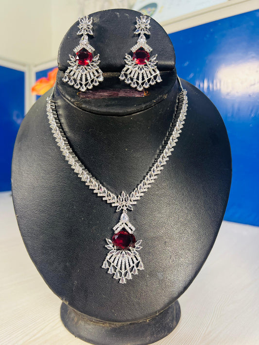 Peacock design ruby necklace AD set with intricate silver detailing displayed on black jewelry stand