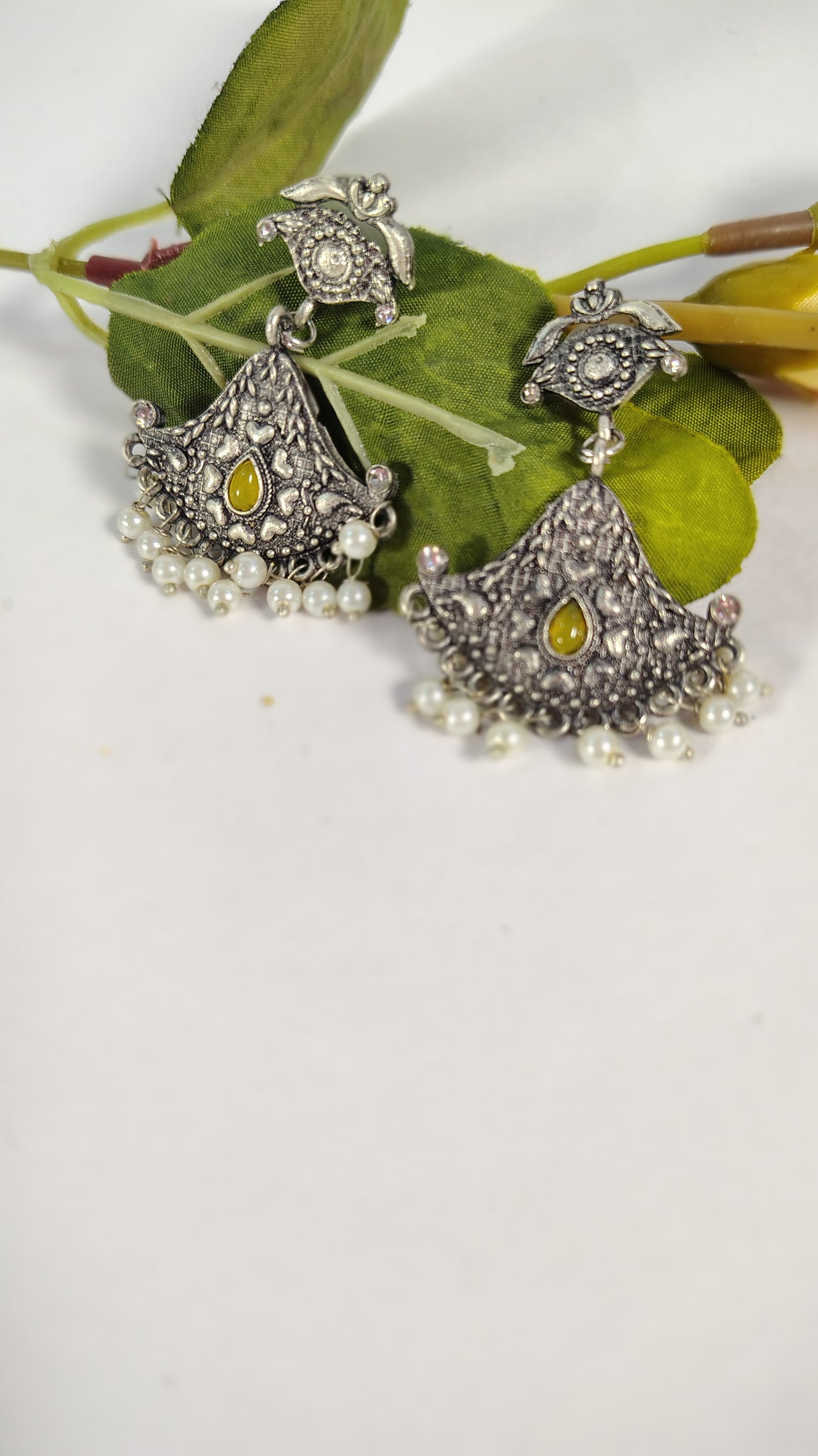 Wincham Fashion House pearl drop hanging earrings with intricate silver design and yellow gemstone accents