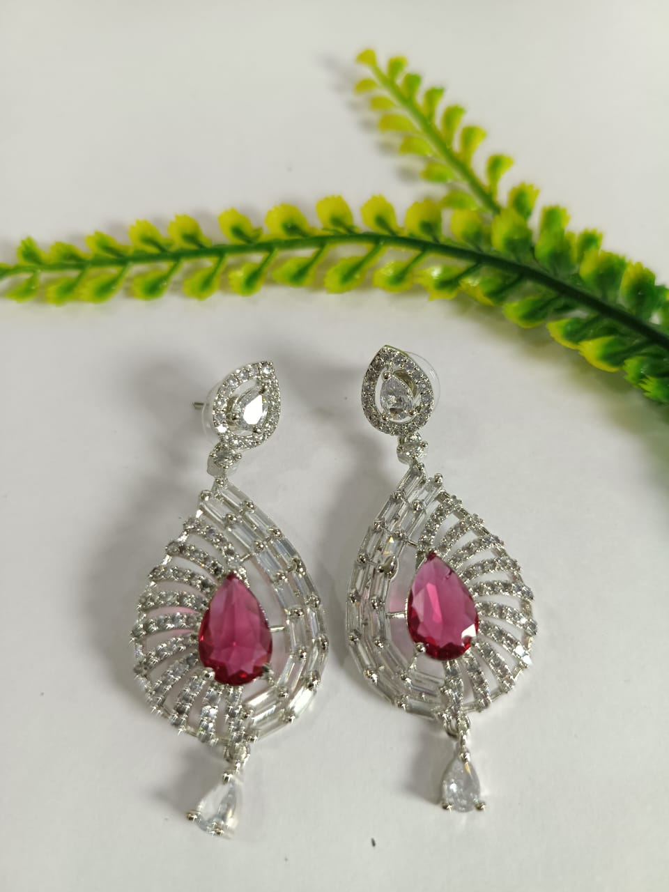 Elegant Wincham Fashion House earrings with ruby in a unique teardrop design adorned with sparkling stones