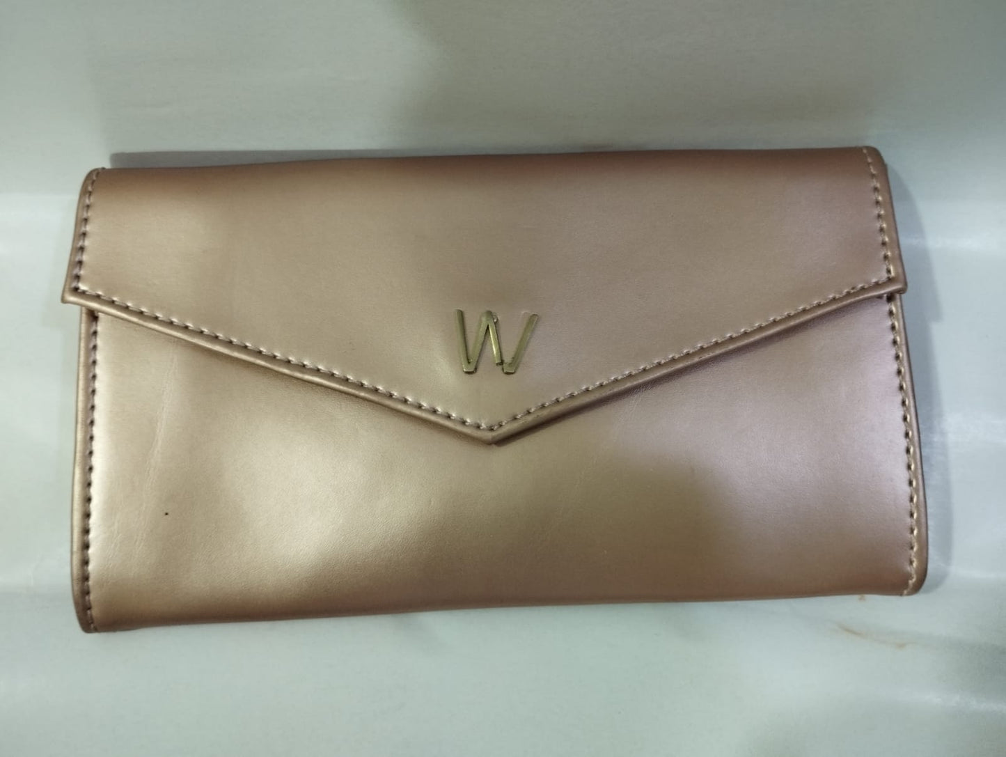 Wincham Fashion House small hand bag purse in rose gold with an elegant design and logo detail