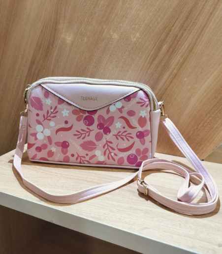 Floral pink crossbody bag for women with adjustable strap and vibrant flower patterns