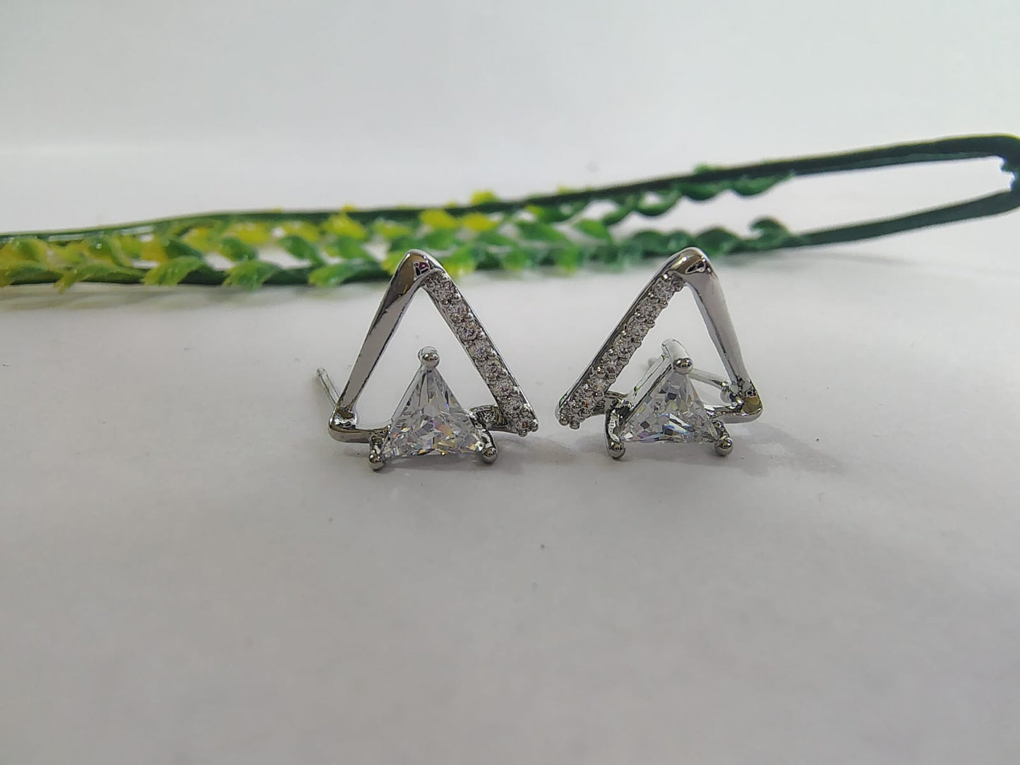 Stylish triangle silver earrings with sparkling stones, perfect for pairing with trendy tops