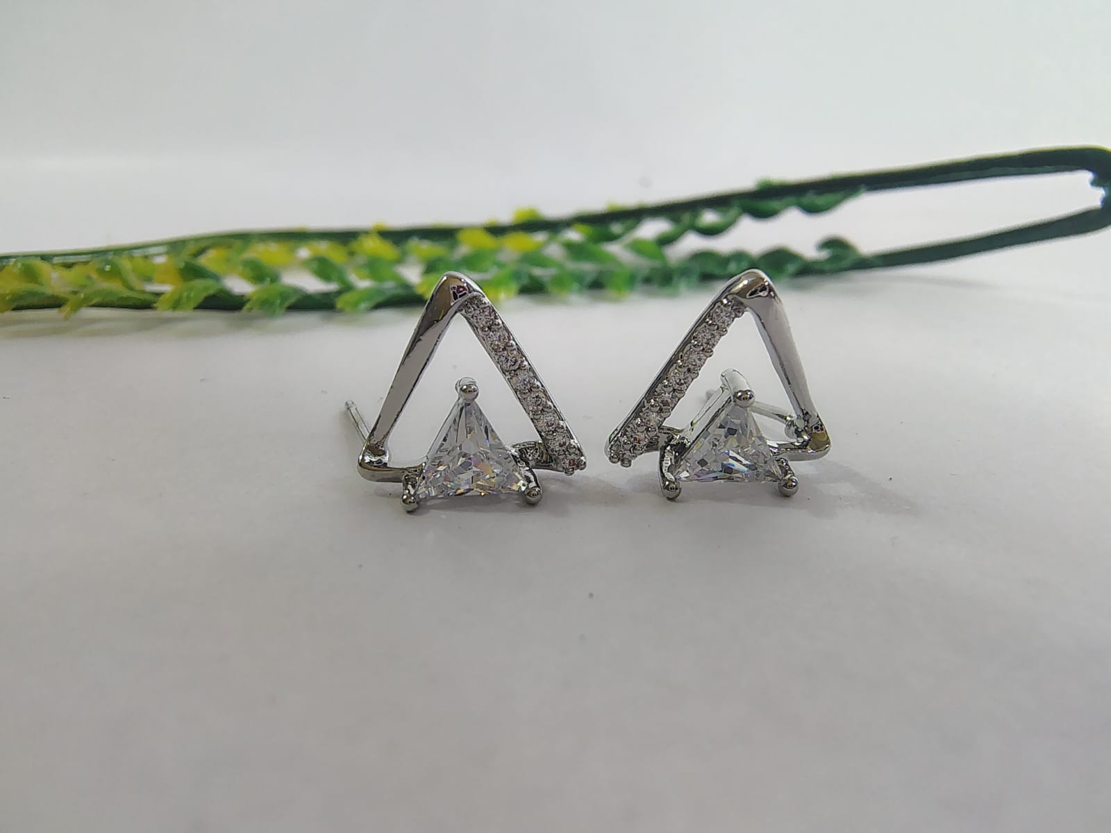 Stylish triangle silver earrings with sparkling stones, perfect for pairing with trendy tops