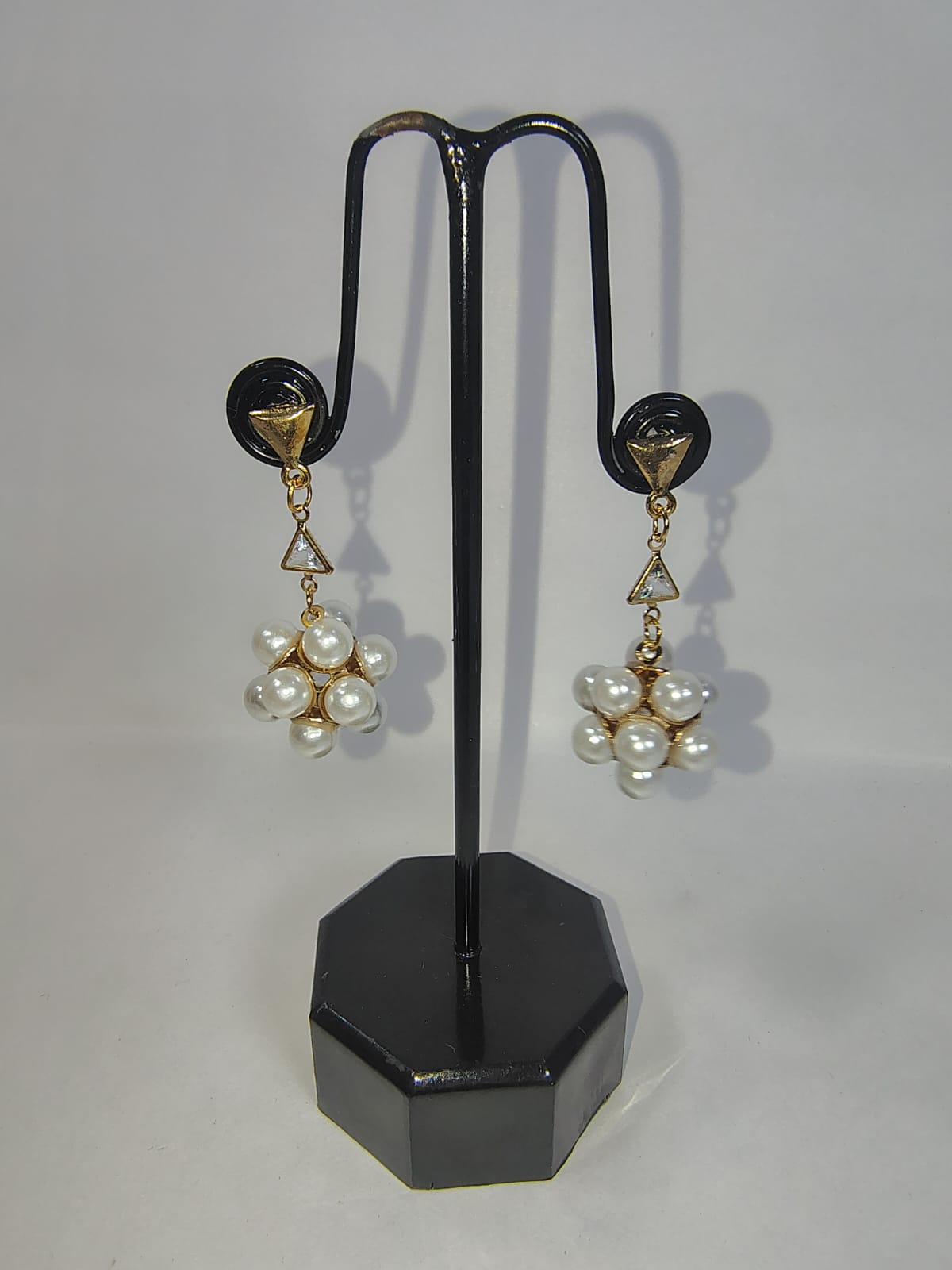 Elegant gold and pearl earrings on display, showcasing women with pearl earrings for sophisticated style.