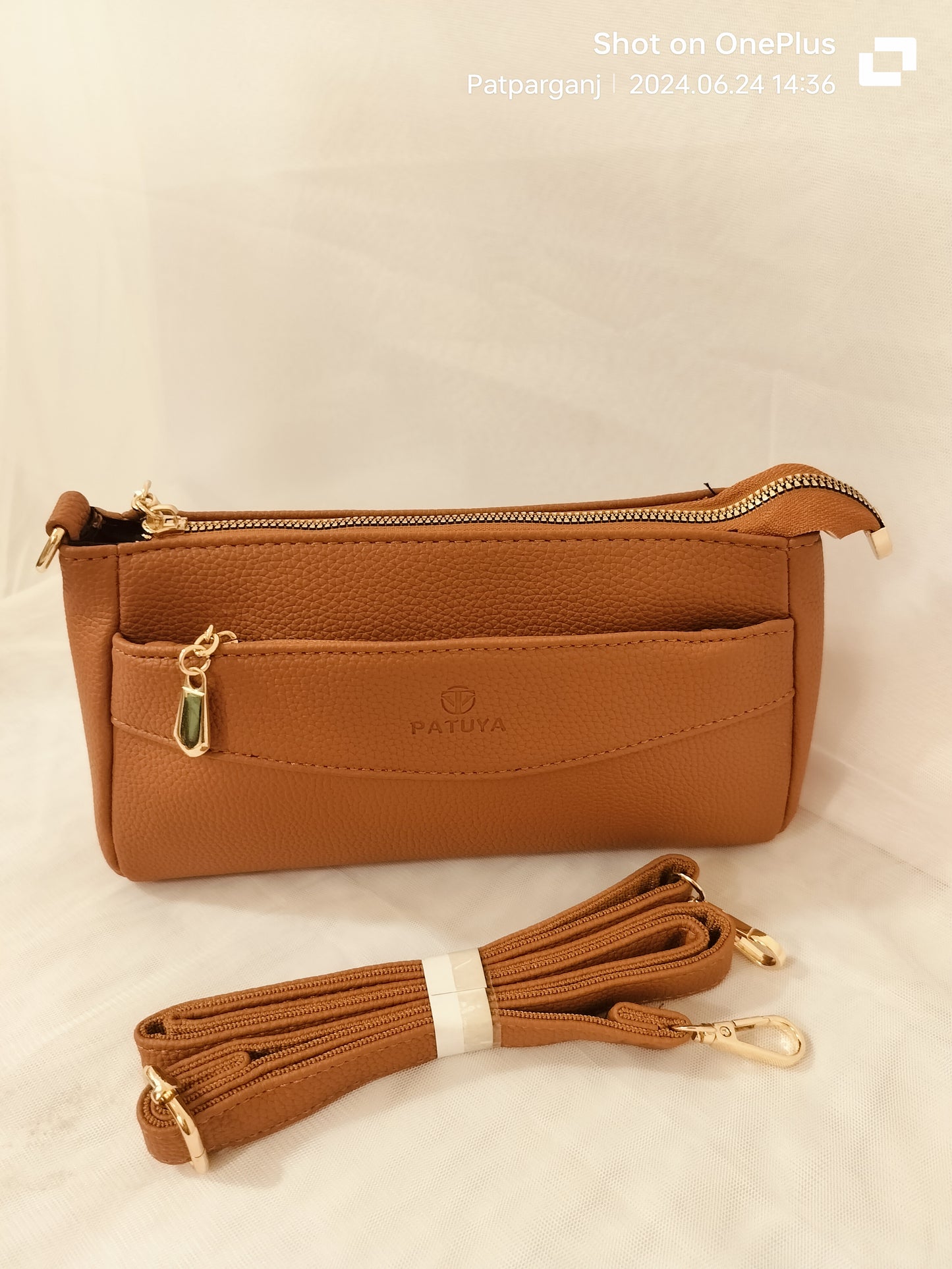 Brown women's leather crossbody bag with gold zipper and detachable strap
