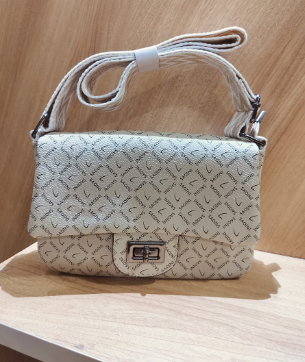 women's off white crossbody bag with belt featuring a patterned design and a metal clasp closure