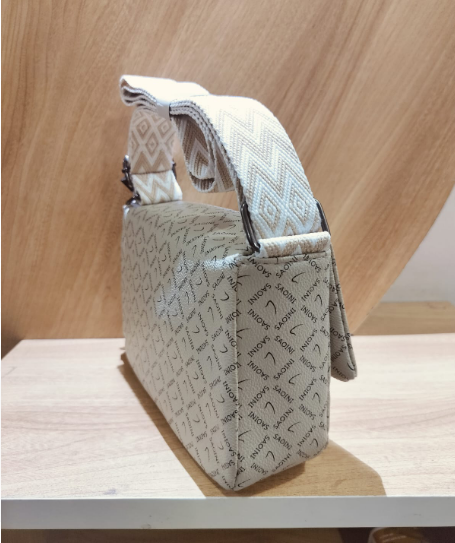 Women's off white crossbody bag with belt featuring patterned strap and all-over logo design