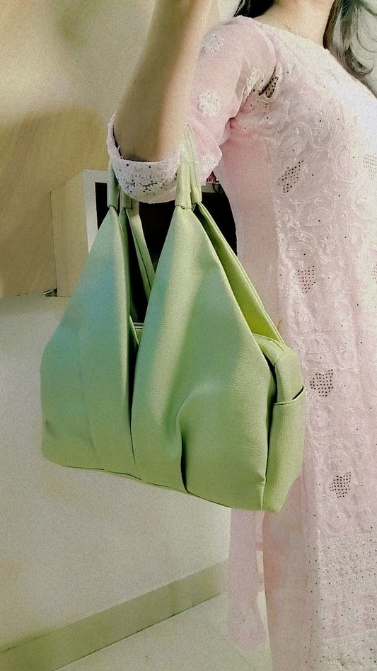 Women's tote shoulder bag olive green by Wincham Fashion House held by a woman in a pink lace dress