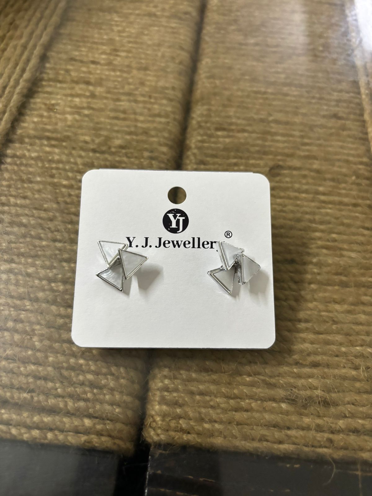 Korean triangle silver earrings displayed on YJ Jewellery card by Wincham Fashion House